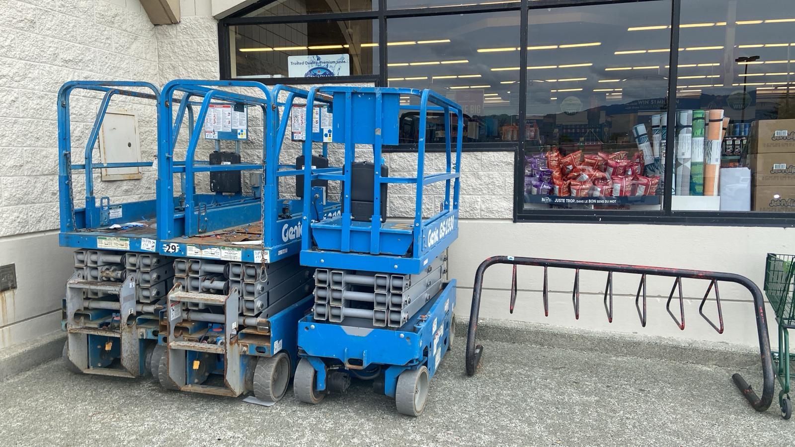 Our blue Genie scissor lifts parked at a local job site
